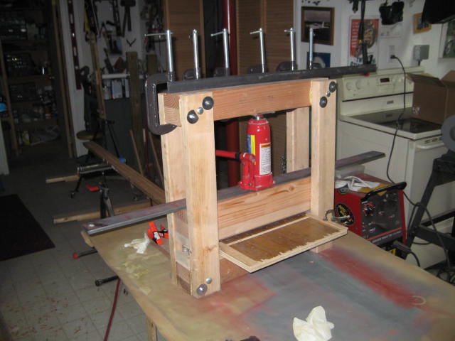 Aileron press with C-clamped angle iron.